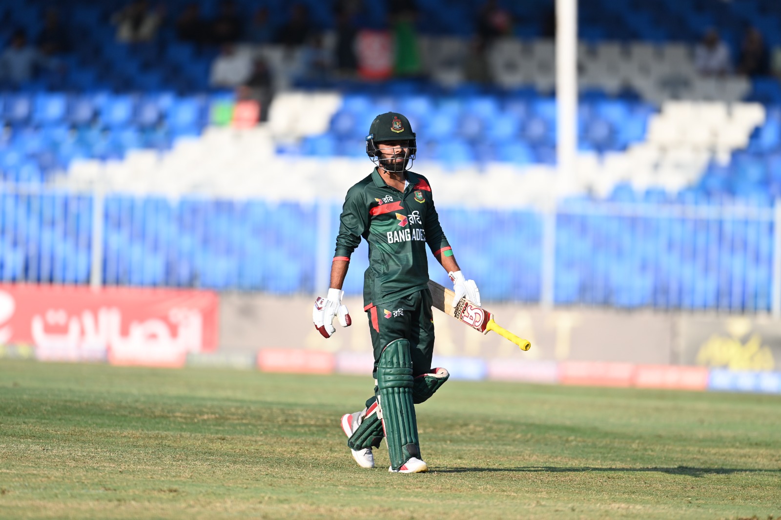 Towhid Hridoy walking off the field in Bangladesh kit